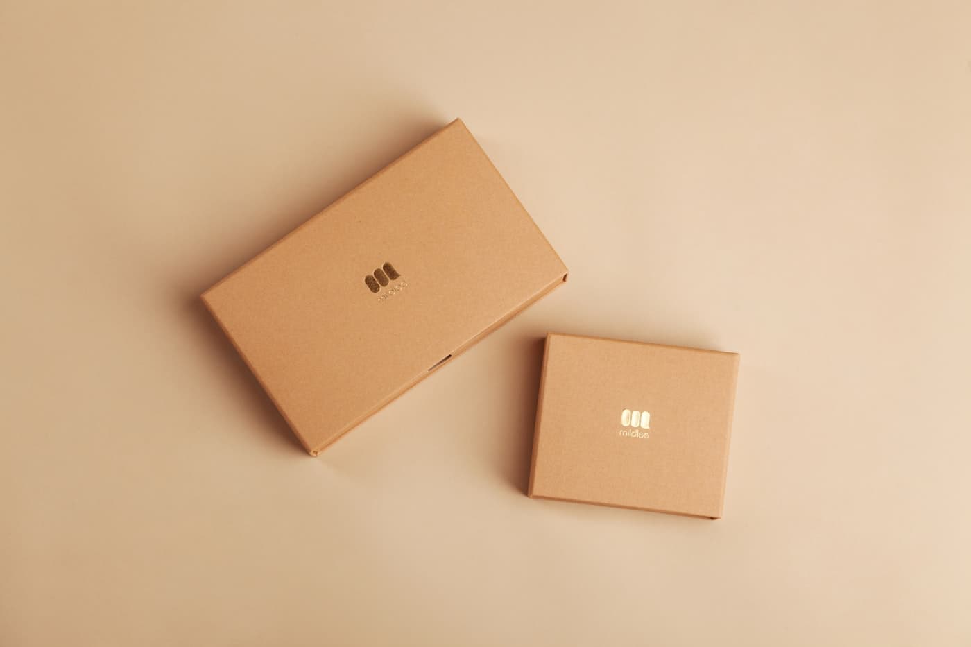 Kraft packaging boxes on a warm neutral background